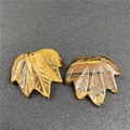 Detailed macro view of leaf-shaped Tiger Eye pendants with intricate engraved veins - Tiger Eye (1Pc)