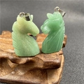 Detailed view of hand-carved tiger eye and green gemstone unicorn horse pendants - Green Aventurine Horse Head Style