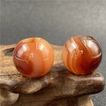 Macro shot of 20mm polished agate beads with natural patterns and large holes for DIY - Red Agate (1 Piece)