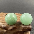 Macro view of two 20mm green aventurine loose beads with large holes on wood base - Green Aventurine (1 Piece)