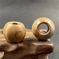 Macro shot of 20mm natural picture jasper beads with large holes on a wooden stand - Picture Jasper (1 Piece)