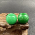 Macro detail of green aventurine stone beads with natural oily luster on wood base - Malay Jade (1 Piece)