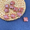 Macro shot of goldstone four-leaf clover beads for DIY jewelry making and crafts - Reddish Brown