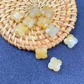 Detailed view of yellow aventurine clover-shaped beads for DIY jewelry and hairpins - Yellow