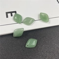 Macro shot of five diamond-shaped green aventurine stone beads for DIY jewelry making - Green Aventurine