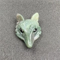 Detailed view of fox head pendant hand-carved from green natural gemstone with black eyes - Indian Agate (1 Piece)