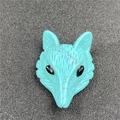 Macro shot of hand-carved turquoise fox pendant with detailed textures and black bead eyes - Synthetic Blue Turquoise (1 Piece)
