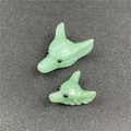 Close-up of green natural stone wolf head carvings with detailed fur texture - Light Green