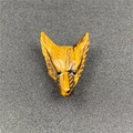 Detailed close-up of a hand-carved natural tiger eye wolf head pendant with golden texture - Tan