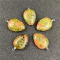Macro detail of five unakite teardrop pendants with polished green and orange patterns - Unakite