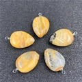Teardrop crystal pendants in yellow agate set with silver bails on a display mat - Crazy Agate
