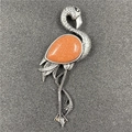 Retro silver flamingo brooch featuring a teardrop orange sunstone and feather details - Goldstone Style (Synthetic)