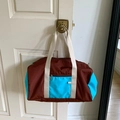 Large nylon tote bag in contrast brown and blue design hanging on a white door - Chestnut