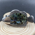 Dettaglio macro della spilla a forma di pesce con conchiglia di abalone e metallo argento - Conchiglia di abalone