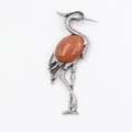 Silver crane brooch with detailed feather texture and oval orange goldstone inlay - Synthetic Goldstone