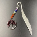 Close-up of silver feather bookmark with seven chakra beads and tree of life charm - Garnet