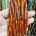 Dettaglio di perline a tubo in agata rossa con trama naturale per gioielli fai-da-te - Agata rossa