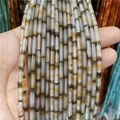 Macro shot of 3x12mm natural silk agate cylinder beads with unique brown striped patterns - Coffee Striped