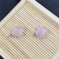 Detailed view of faceted pink quartz flower charms with silver metal pendant loops - Rose Quartz Pendant
