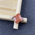 Detailed view of a four-leaf clover brown sandstone connector with silver metal loops - Gold Sandstone Connector (Synthetic)