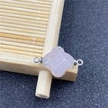 Close-up of rose quartz quatrefoil flower connector with faceted gemstone and silver rings - Rose Quartz Connector