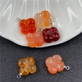 Macro shot of carved agate four-leaf clover flower charms with silver metal loops - Red Agate