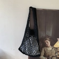 Handmade black woven mesh tote bag with diamond pattern hanging on a vintage art frame - Black (with inner bag)