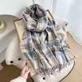 Cozy blue and beige plaid scarf with fringed edges displayed on a white chair - Sky Blue
