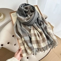 Plaid tassel scarf in grey and beige tones on a wooden tray with winter cozy vibes - Gray