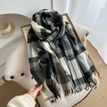 Thick black grey and beige plaid cashmere scarf with soft fringes in a home setting - Grey Black Plaid