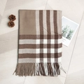 Plaid knitted scarf in khaki and brown with fringe tassels on a wooden background - Khaki