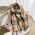 Thick beige and black plaid scarf with tassels in a warm and cozy home setting - Light Brown