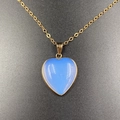 Light blue heart-shaped opal pendant necklace with elegant gold-plated edging detail - Synthetic Opal