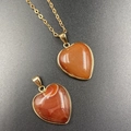 Red agate heart pendant with gold edge and delicate chain over dark matte background - Red Agate