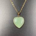 Green heart-shaped stone pendant with gold-plated edging on a delicate gold chain necklace - Green Aventurine