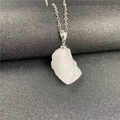 Detail of raw white crystal pendant with natural texture and silver chain necklace - Rose Quartz