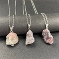 Detail of irregular natural raw amethyst and rose quartz pendants on slim silver chains - Pink Tourmaline