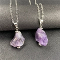 Close-up of irregular amethyst raw stone pendants with silver textured chains - Dark Amethyst
