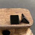 Close-up of polished black agate pyramid stone with sharp geometric edges and glossy finish - Black Agate