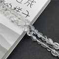 Macro shot of irregular clear quartz crystal beads with natural internal texture detail - White Crystal