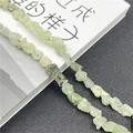 Close-up of irregular pale green natural gemstone beads with translucent texture - Prehnite 1 Strand
