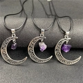 Close-up of hollow crescent moon pendant with raw purple amethyst on black wax cord - Amethyst