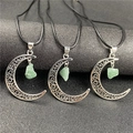 Detail of three hollow moon pendants with green raw stone on black cord necklaces - Amazonite