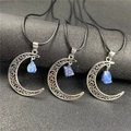 Detailed view of silver crescent moon pendants with raw blue gemstones on black cords - Lapis Lazuli