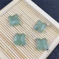 Light green quartz clover charm pendants with silver metal connectors on wood - Green Aventurine Pendant