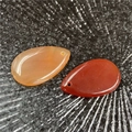 Polished teardrop agate pendants in translucent honey and deep carnelian red tones - Red Agate