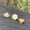 Polished yellow quartz crystal pyramids and hexagonal stones on rustic wood surface - Topaz