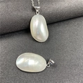 Detailed macro view of natural iridescent mother-of-pearl pendants on a dark background - 40-50mm / White with Border