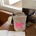 Cream sherpa bucket bag with pink letter M embroidery and adjustable black strap - Off White