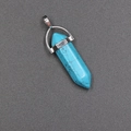 Natural turquoise bullet pendant with silver metal cap on a textured background - Synthetic Blue Turquoise